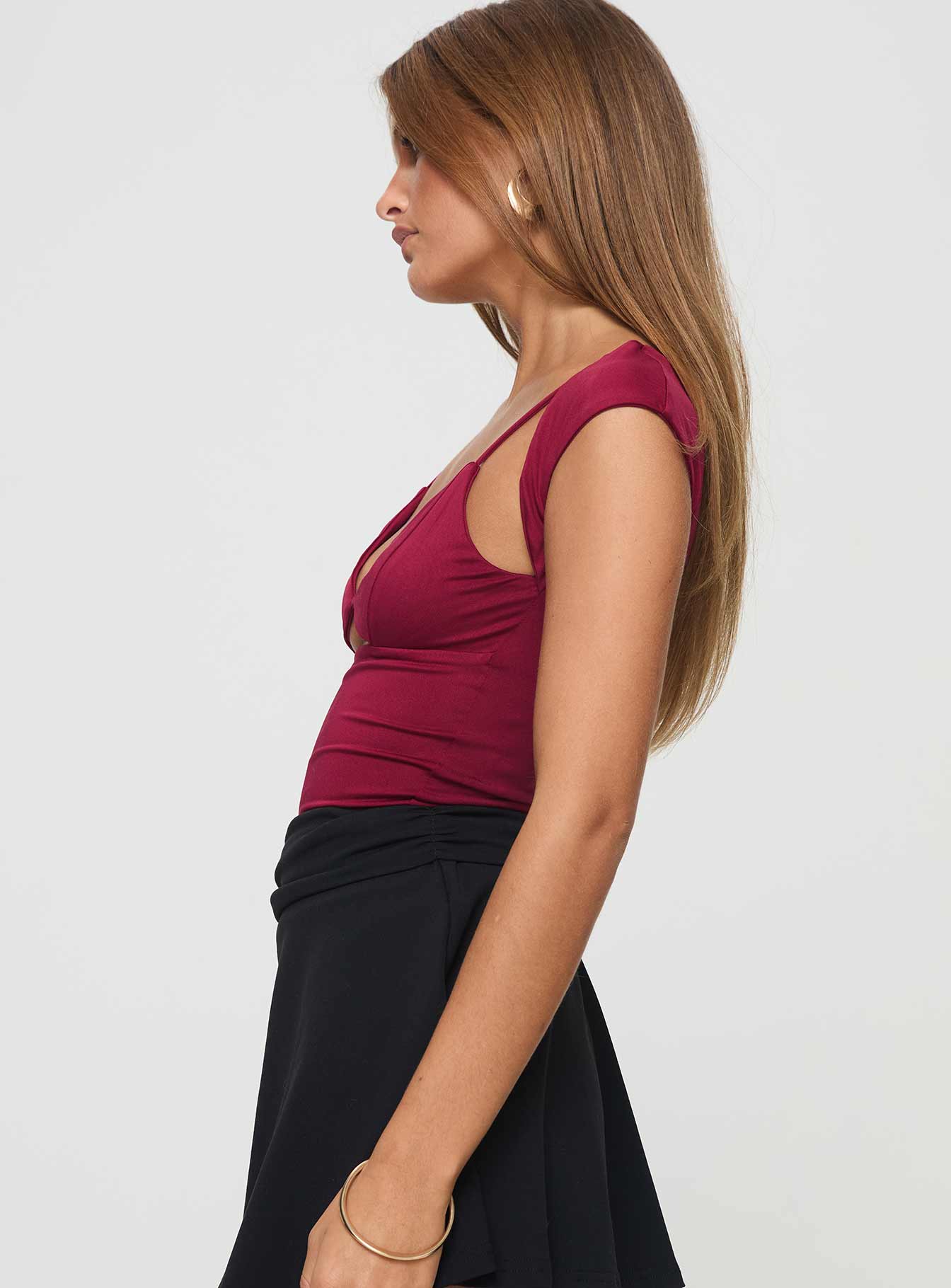 side view of model wearing Princess Polly Bolden Top Burgundy Short Sleeves V-Neck 