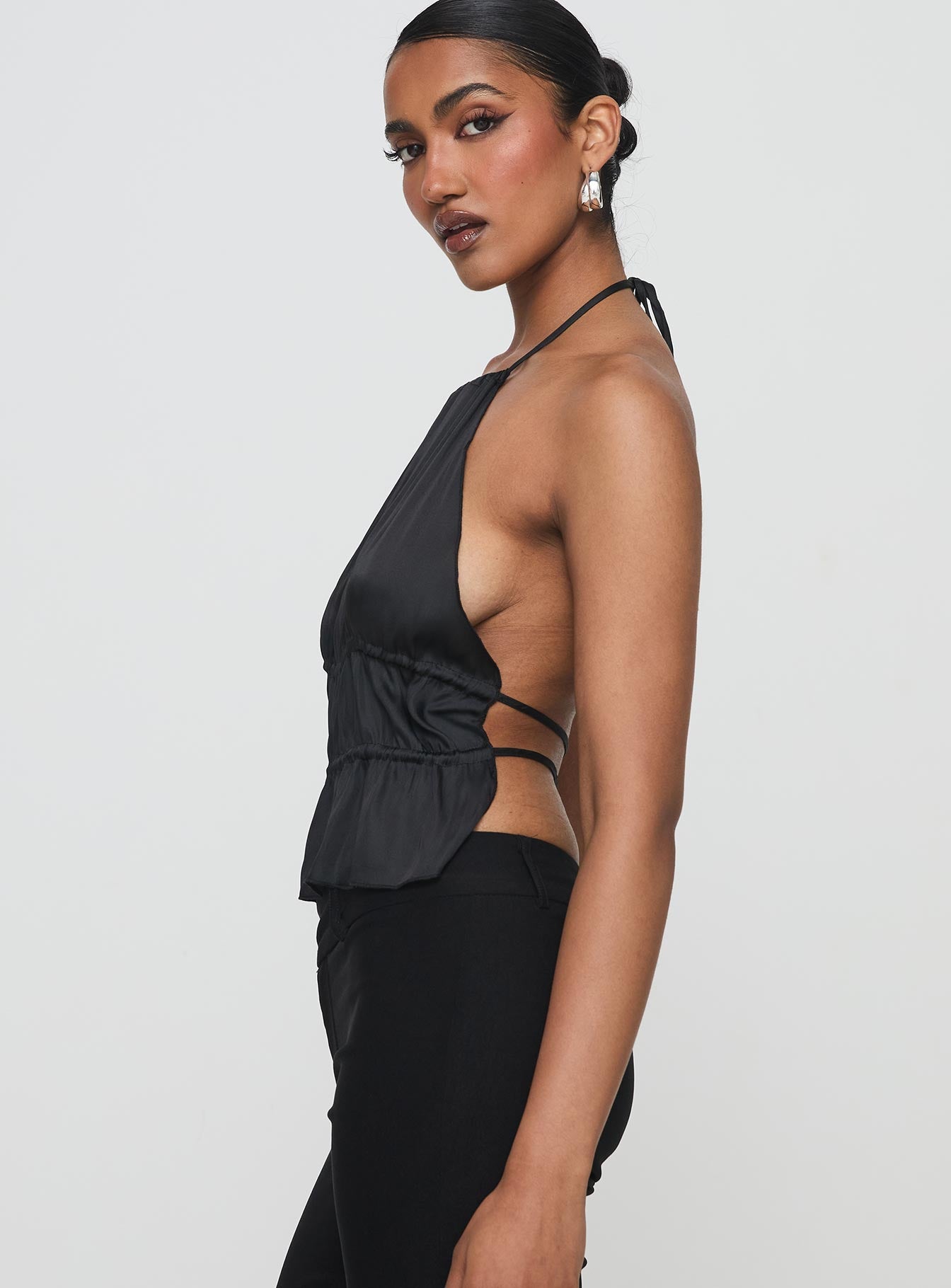 side view of model wearing Princess Polly Legacy Halter Top Onyx Sleeveless High Neck 