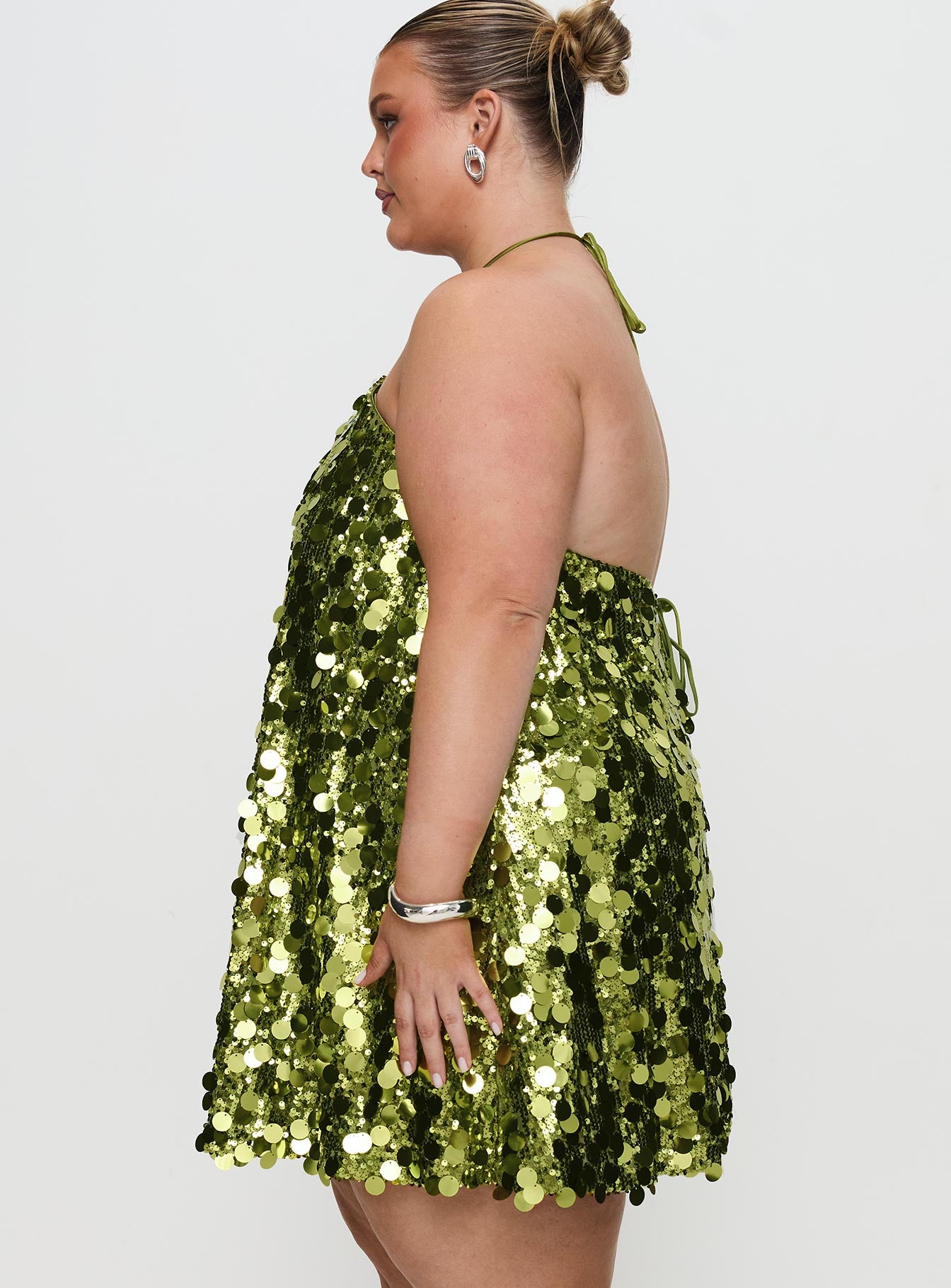 side view of model wearing Princess Polly Fluorescents Halter Mini Dress Green Curve Asymmetric Neckline 