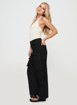 side view of model wearing Princess Polly Humphrey Cargo Pant Black Mid Rise 