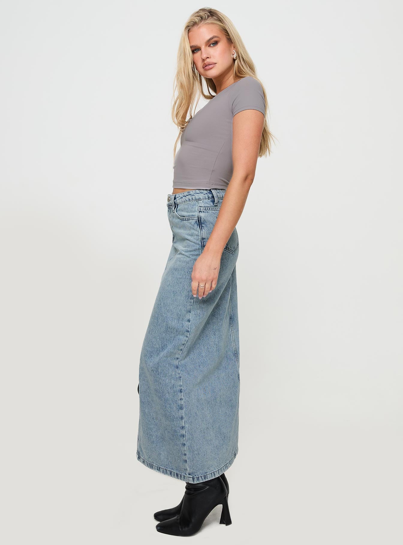   side view of model wearing Princess Polly Saige Denim Maxi Skirt Light Wash Maxi 