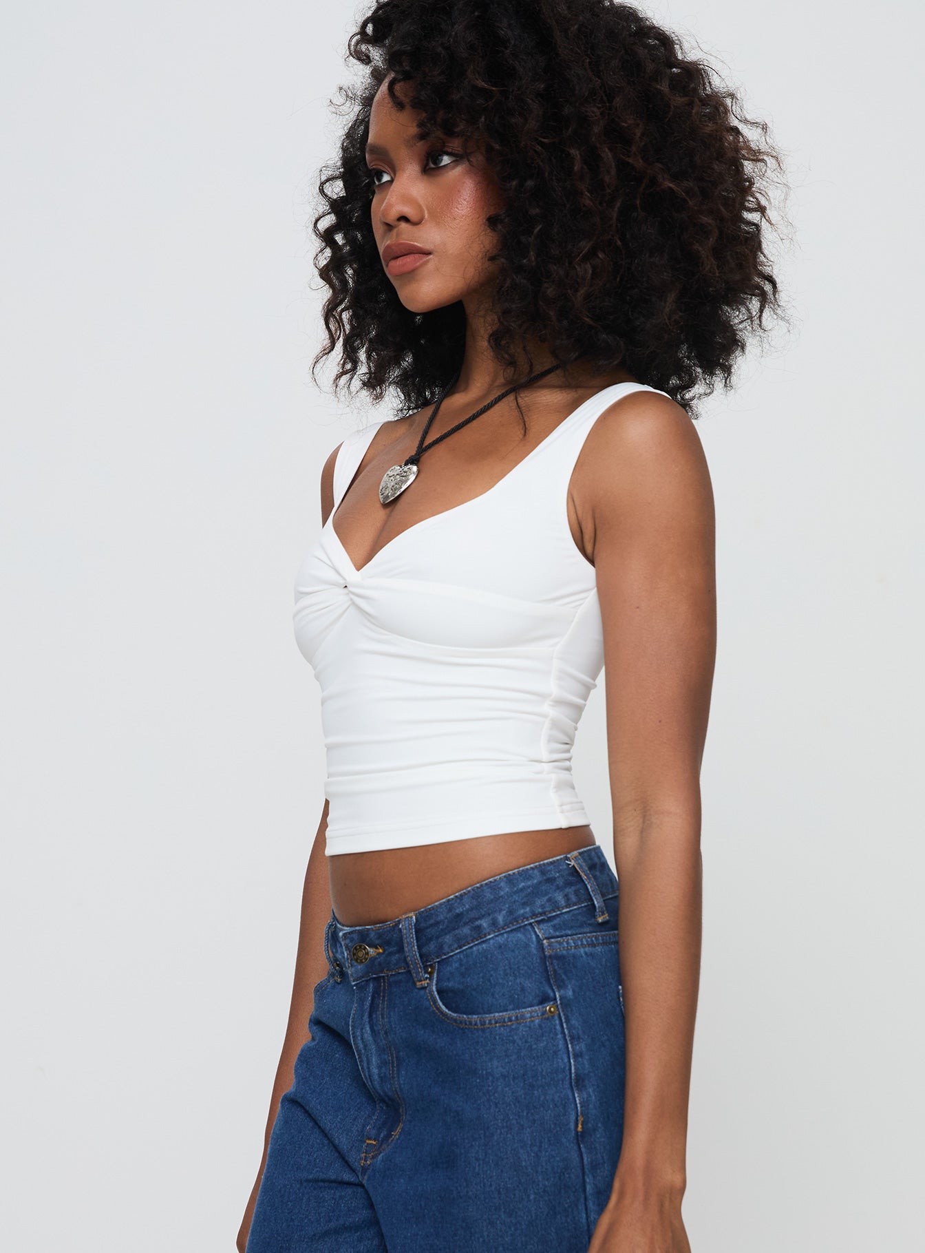 side view of model wearing Princess Polly Una Top White Sleeveless Sweetheart 