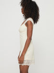 side view of model wearing Princess Polly Quillon Mini Dress Cream Sweetheart Neckline 