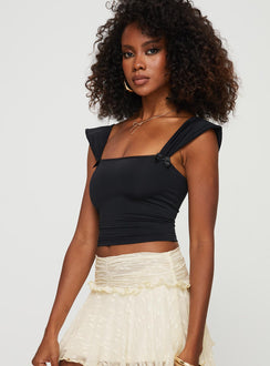 side view of model wearing Princess Polly Farinos Top Black Short Sleeves Square Neck 