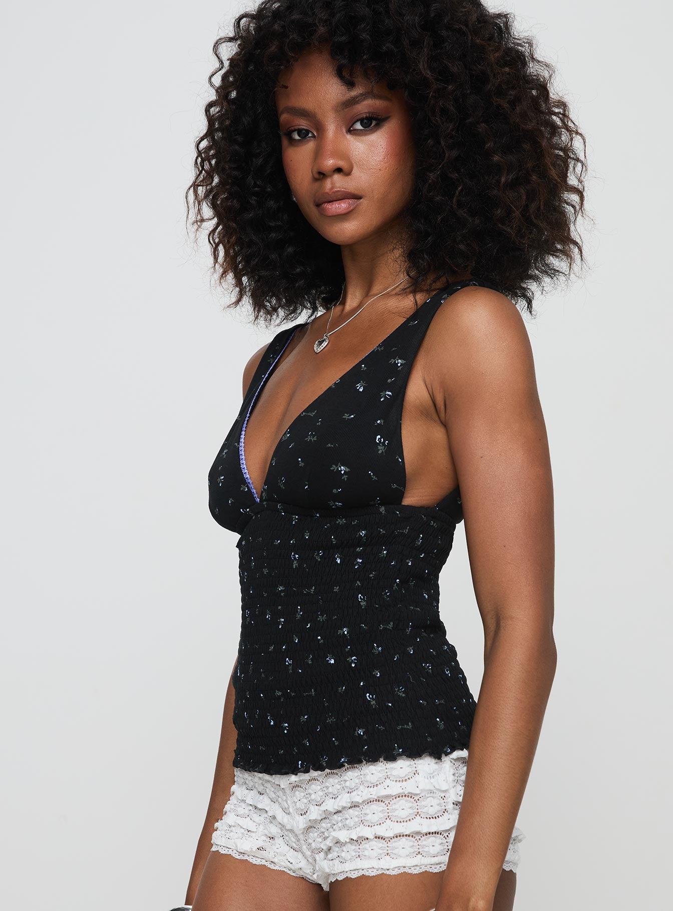 side view of model wearing Princess Polly Comfrey Top Black Sleeveless Plunger 