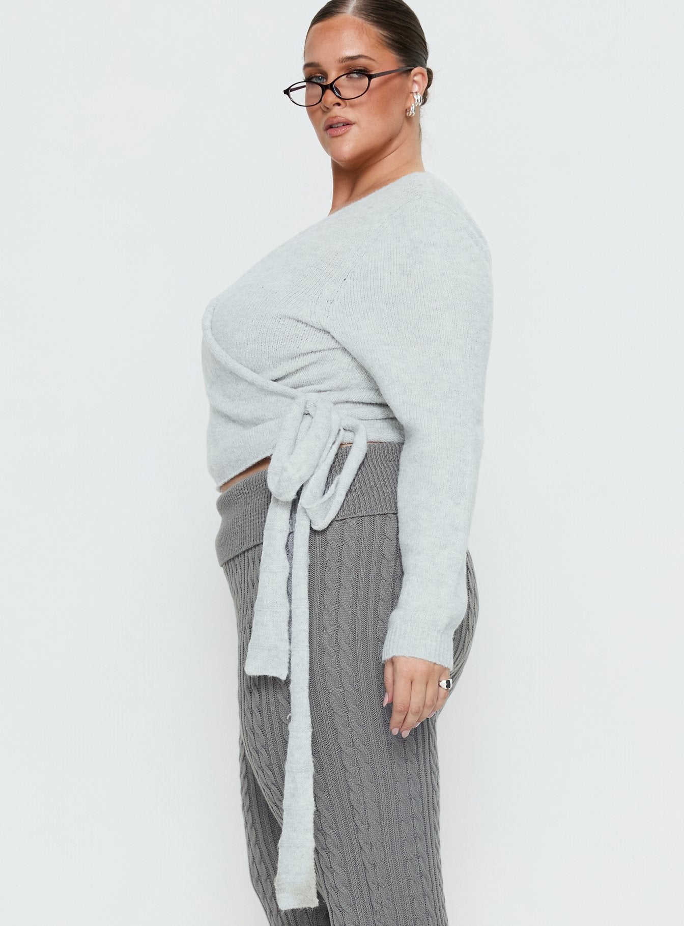 side view of model wearing Princess Polly Tonee Wrap Knit Cardigan Grey Curve cropped 