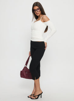 side view of model wearing Princess Polly Baseline Rib Capri Pants Black Petite Mid Rise Pants 