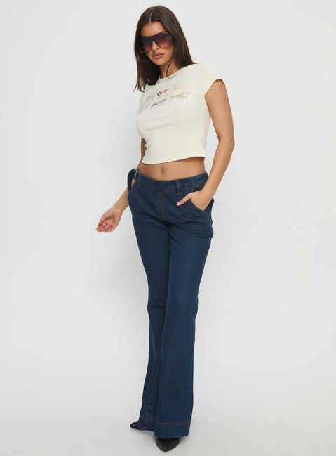 front view of model wearing Princess Polly Acapulco Low Rise Flare Jeans Dark Blue Wash Low Rise Jeans 
