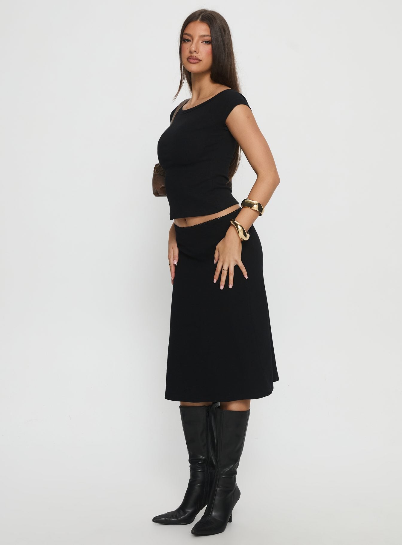   side view of model wearing Princess Polly Baseline Rib Midi Skirt Black Midi Skirts 