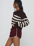 side view of model wearing Princess Polly Moreton Shorts Wine Low Rise Shorts 