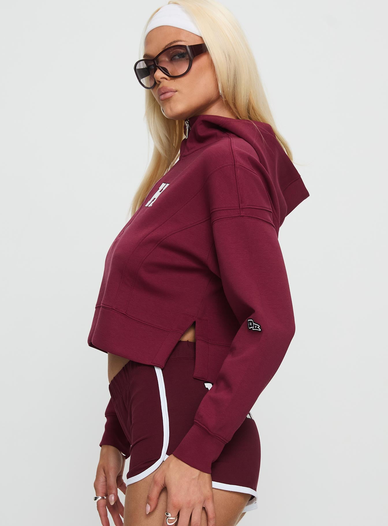 side view of model wearing Princess Polly Harvard Buttersport Half-zip Hoodie Crimson cropped 