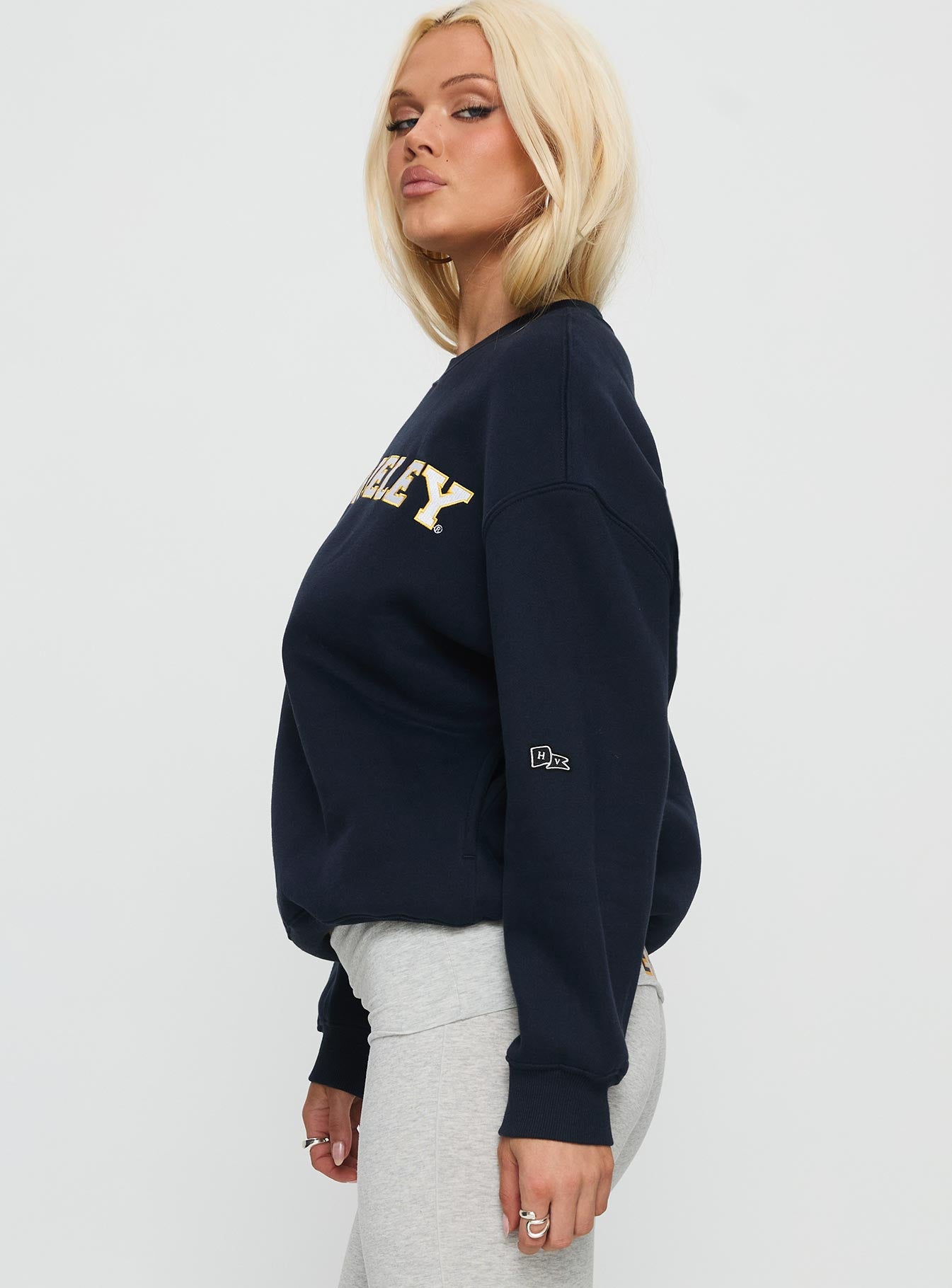 side view of model wearing Princess Polly UC Berkeley Offside Crewneck Sweatshirt Navy 