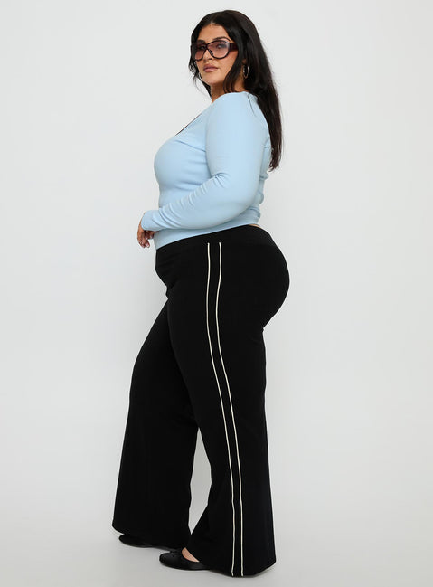 side view of model wearing Princess Polly Ascenda Straight Leg Track Pant Black Curve Mid Rise Pants 