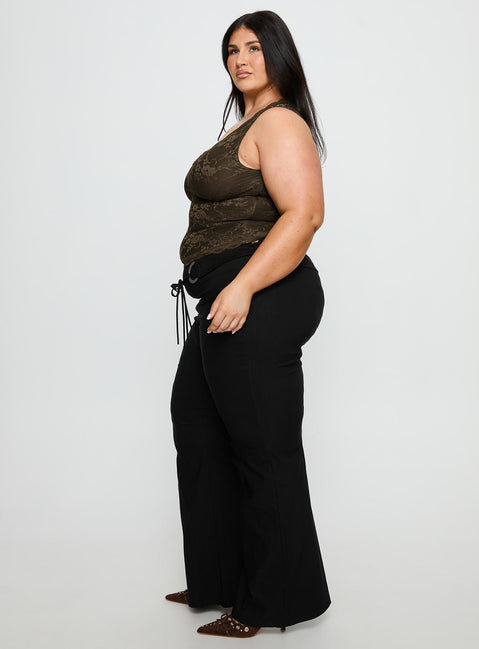 side view of model wearing Princess Polly Twinflame Low Rise Hardware Pants Black Curve Mid Rise Pants 