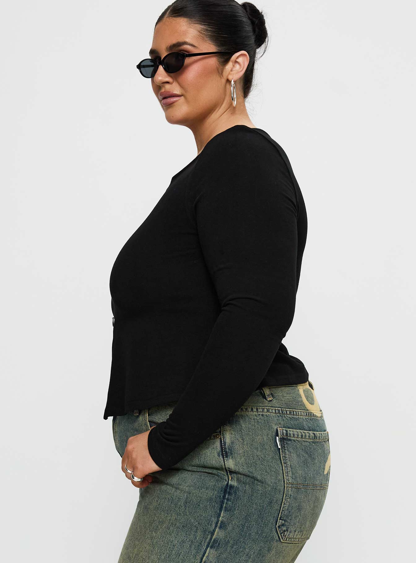 side view of model wearing Princess Polly Kortez Long Sleeve Zip Through Top Black Curve Full Sleeves Crew Neck 