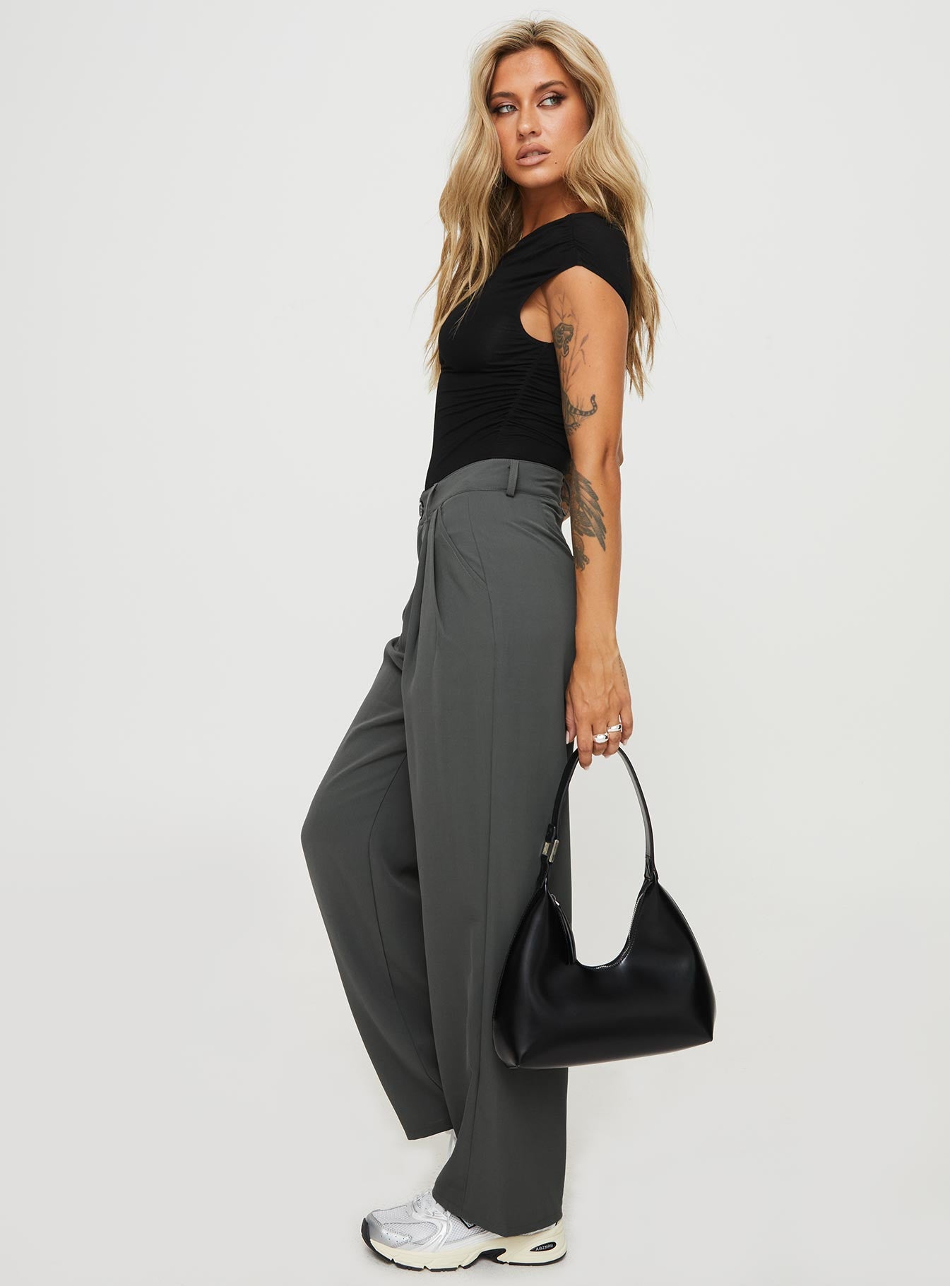 side view of model wearing Princess Polly Nikkey Low Rise Pants Slate Mid Rise 