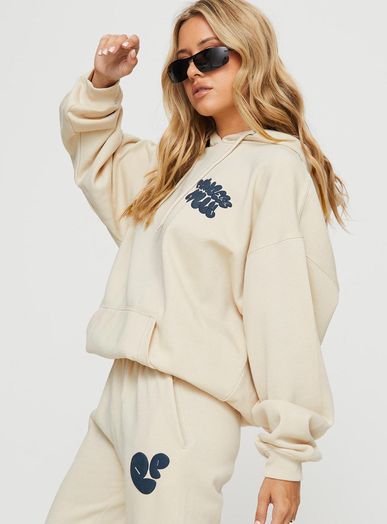 side view of model wearing Princess Polly Princess Polly Hooded Sweatshirt Bubble Text Stone / Slate Long 