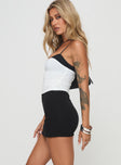 side view of model wearing Princess Polly Karley Skort Black High Waisted Shorts 