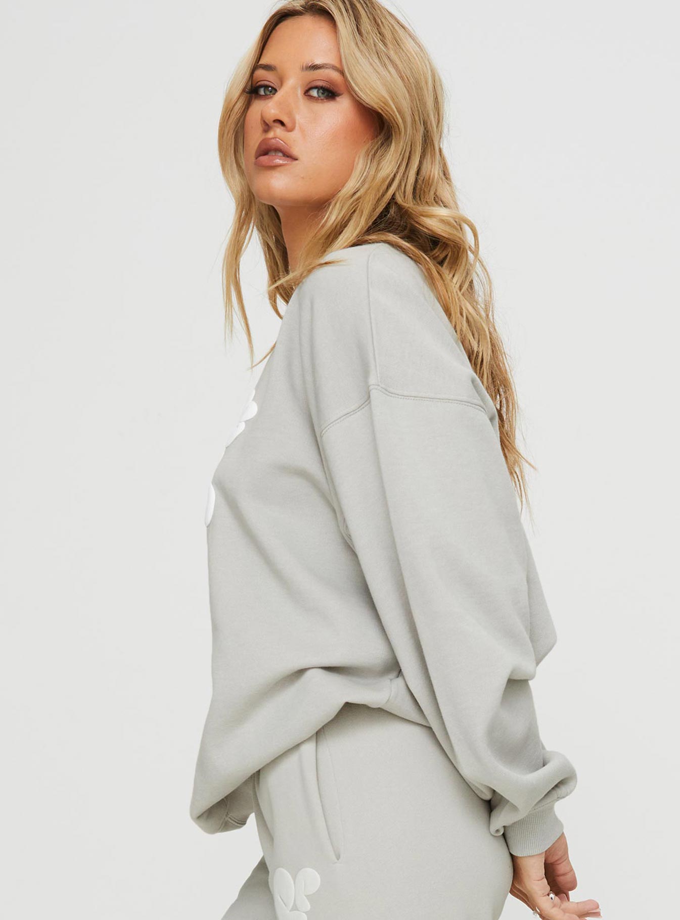 side view of model wearing Princess Polly Princess Polly Crew Neck Sweatshirt Bubble Text Grey / Cloud White Long 