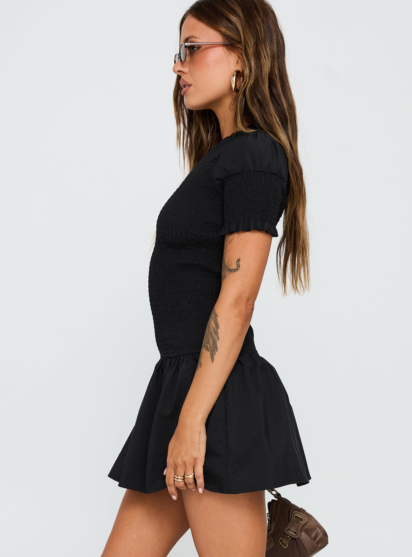 side view of model wearing Princess Polly Laurita Shirred Mini Dress Black High Neck 