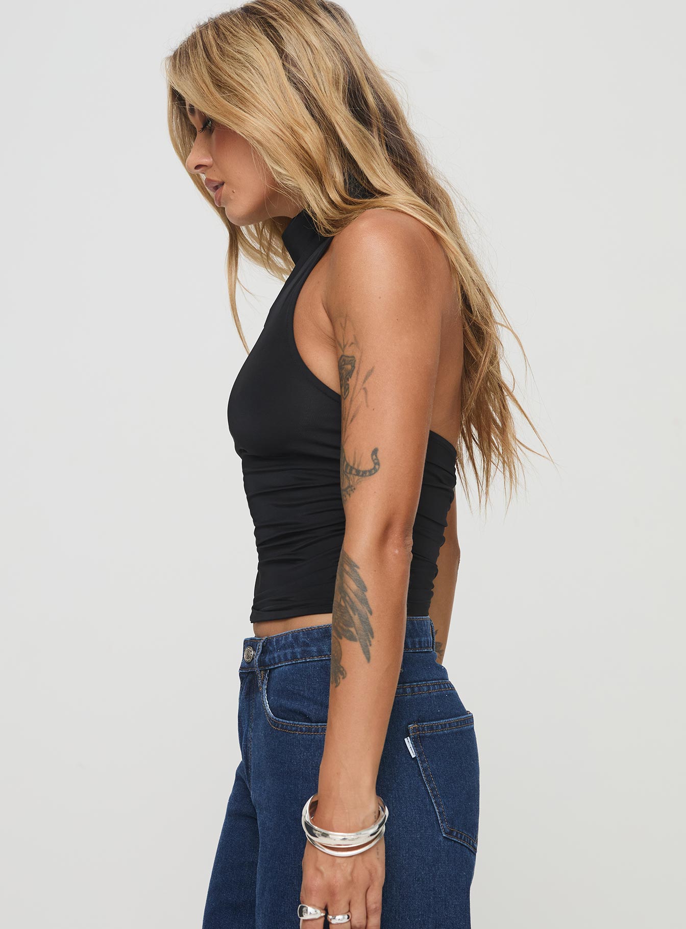 side view of model wearing Princess Polly Giggle Top Black Sleeveless High Neck 