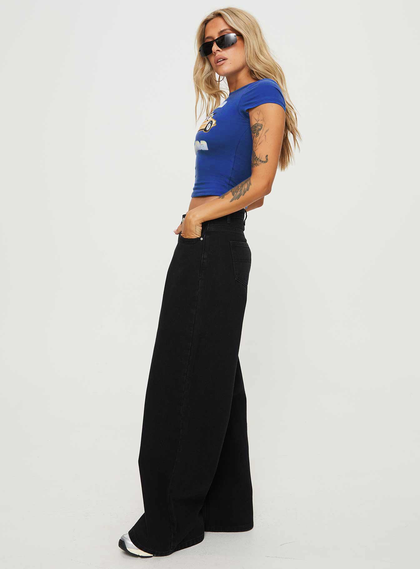 side view of model wearing Princess Polly Naylor Wide Leg Jeans Washed Black Denim Petite High Waisted 