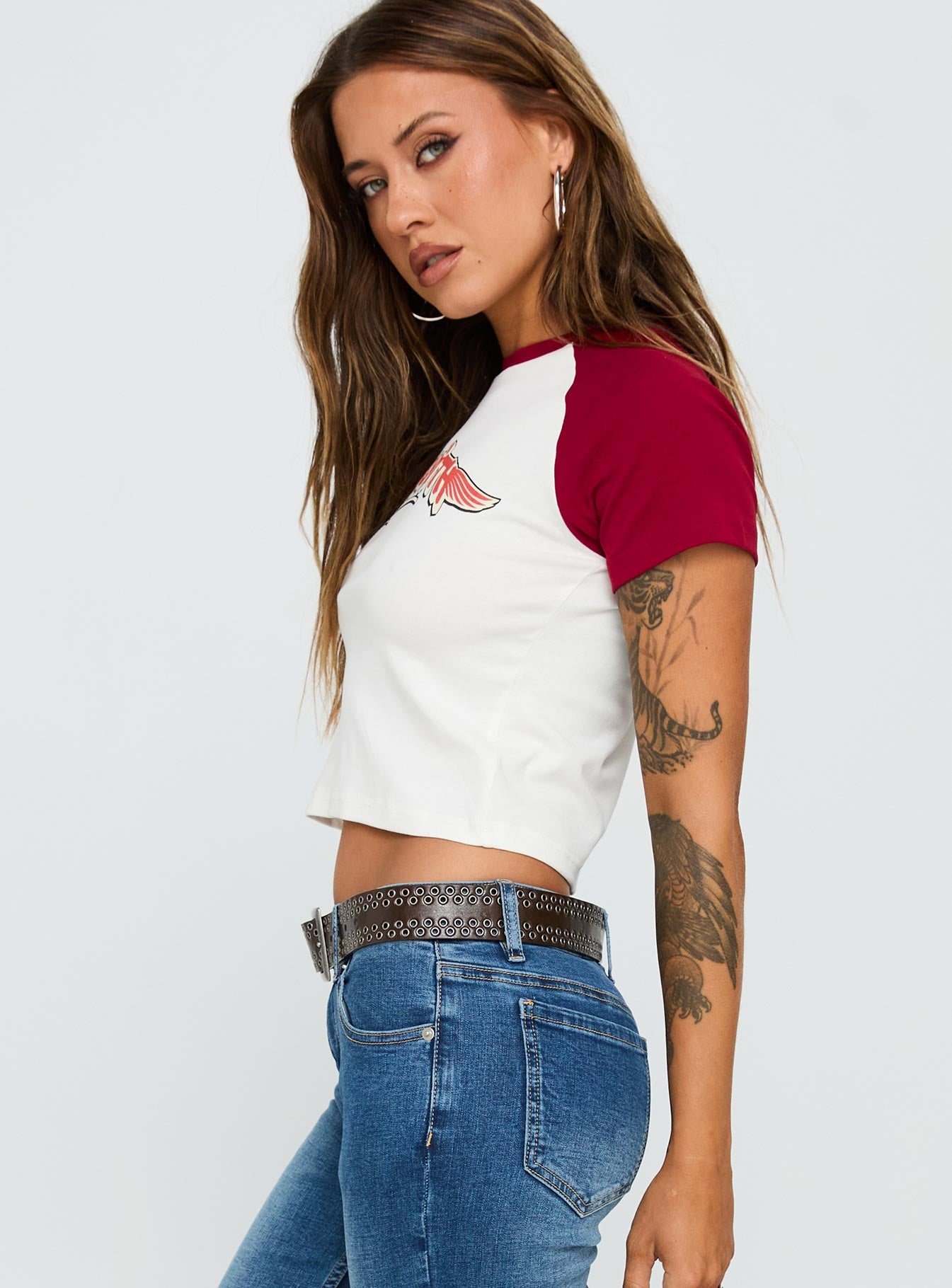 side view of model wearing Princess Polly Let Rock Rule Graphic Top White / Red Short Sleeves Crew Neck 