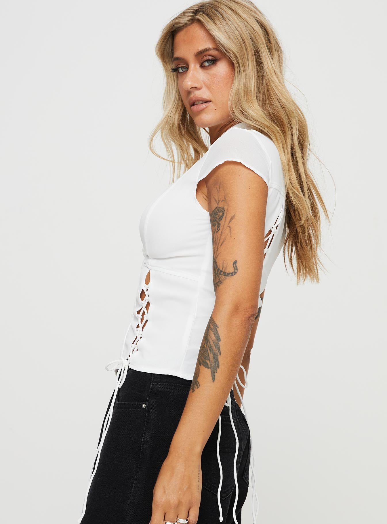 side view of model wearing Princess Polly Valkyrie Top White Short Sleeves High Neck 