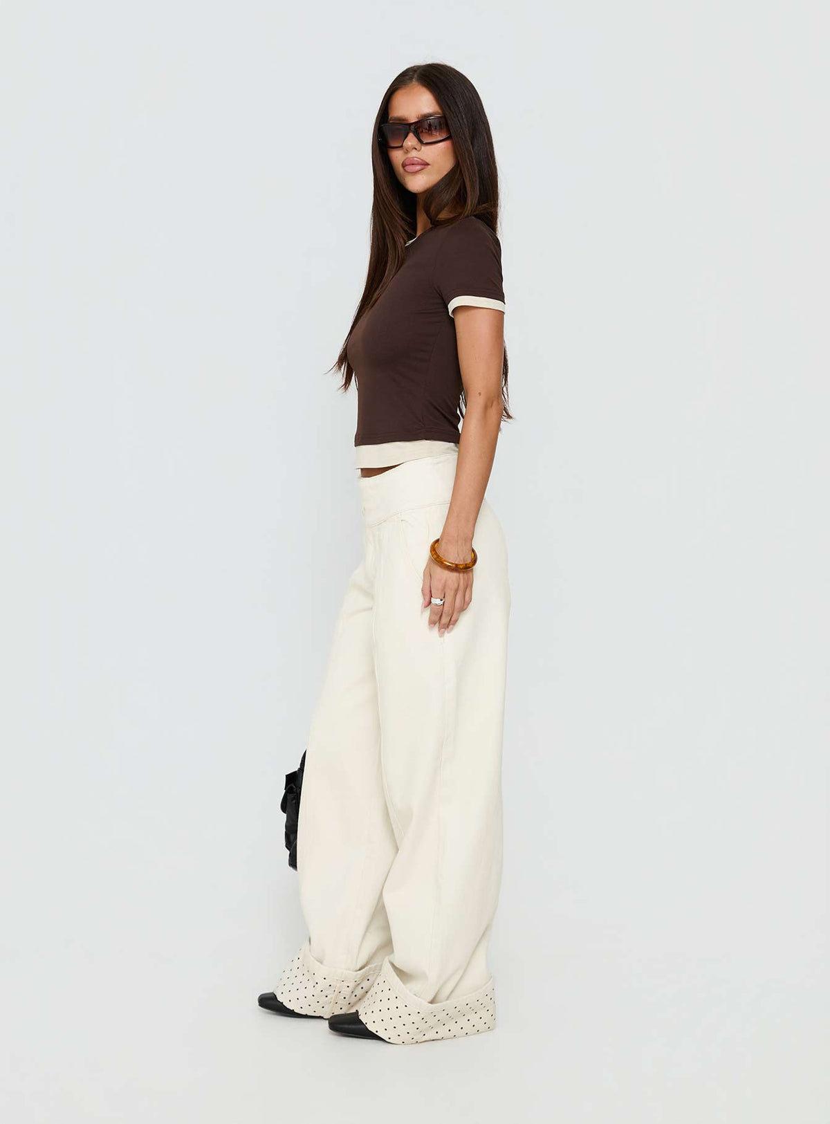 Discover the Nikoletta Foldover Jeans Cream / Polka Petite womens-jeans with high-rise side view of model wearing Princess Polly