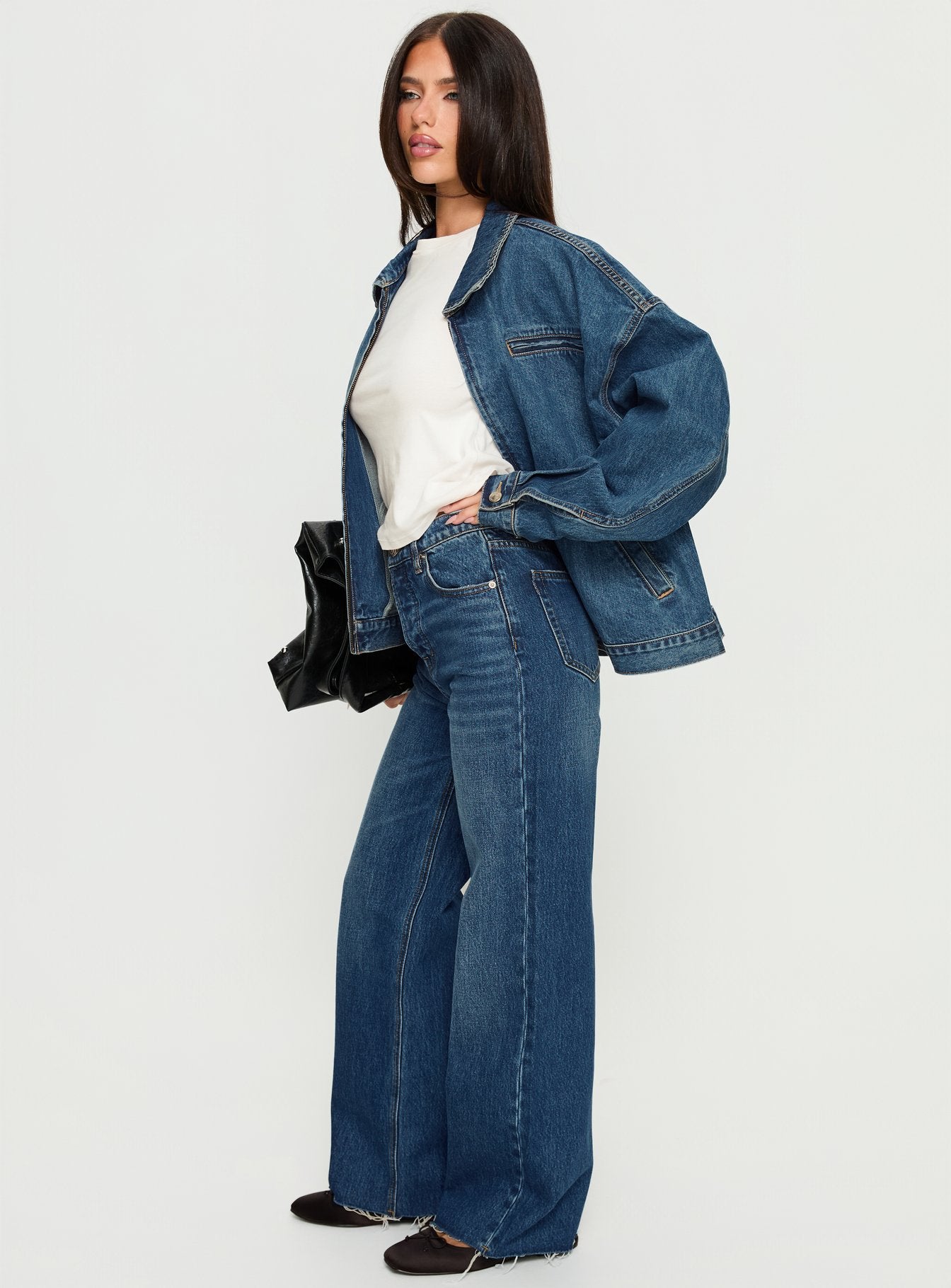 side view of model wearing Princess Polly Fawcett High Rise Straight Leg Jeans Dark Blue Wash High Rise Jeans 