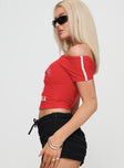 side view of model wearing Princess Polly Serendipia Off The Shoulder Graphic Top Red Short Sleeves straight 