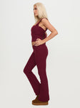 side view of model wearing Princess Polly Closed Eyes Flared Pants Maroon Low Rise Pants 