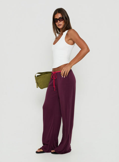 Designed with low-rise waist, the Jessika Ultra Low Pants Red / Plum womens-regular-pants side view of model wearing