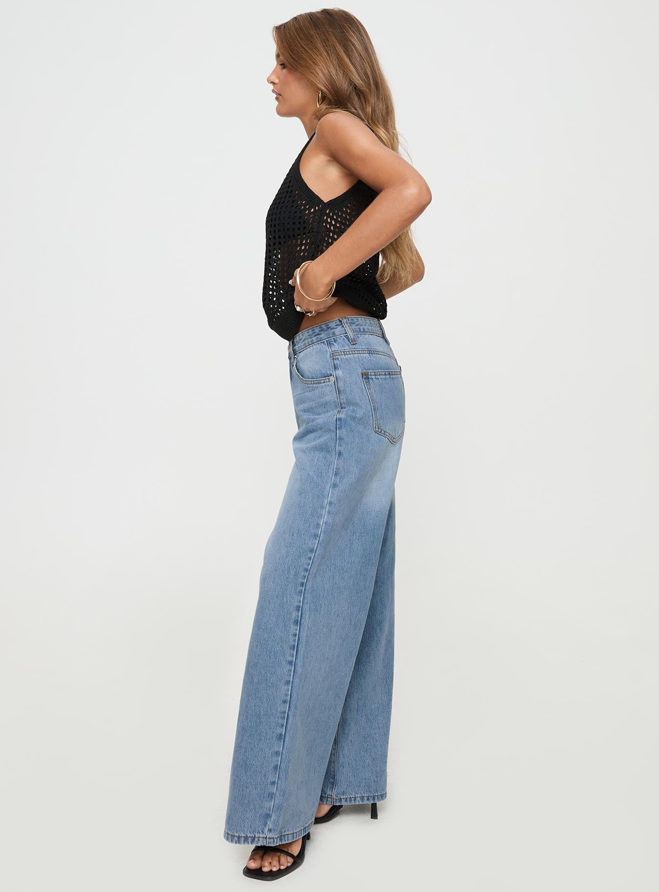 side view of model wearing Princess Polly Colemane Mid Rise Denim Jeans Angel Blue Petite Mid Rise 