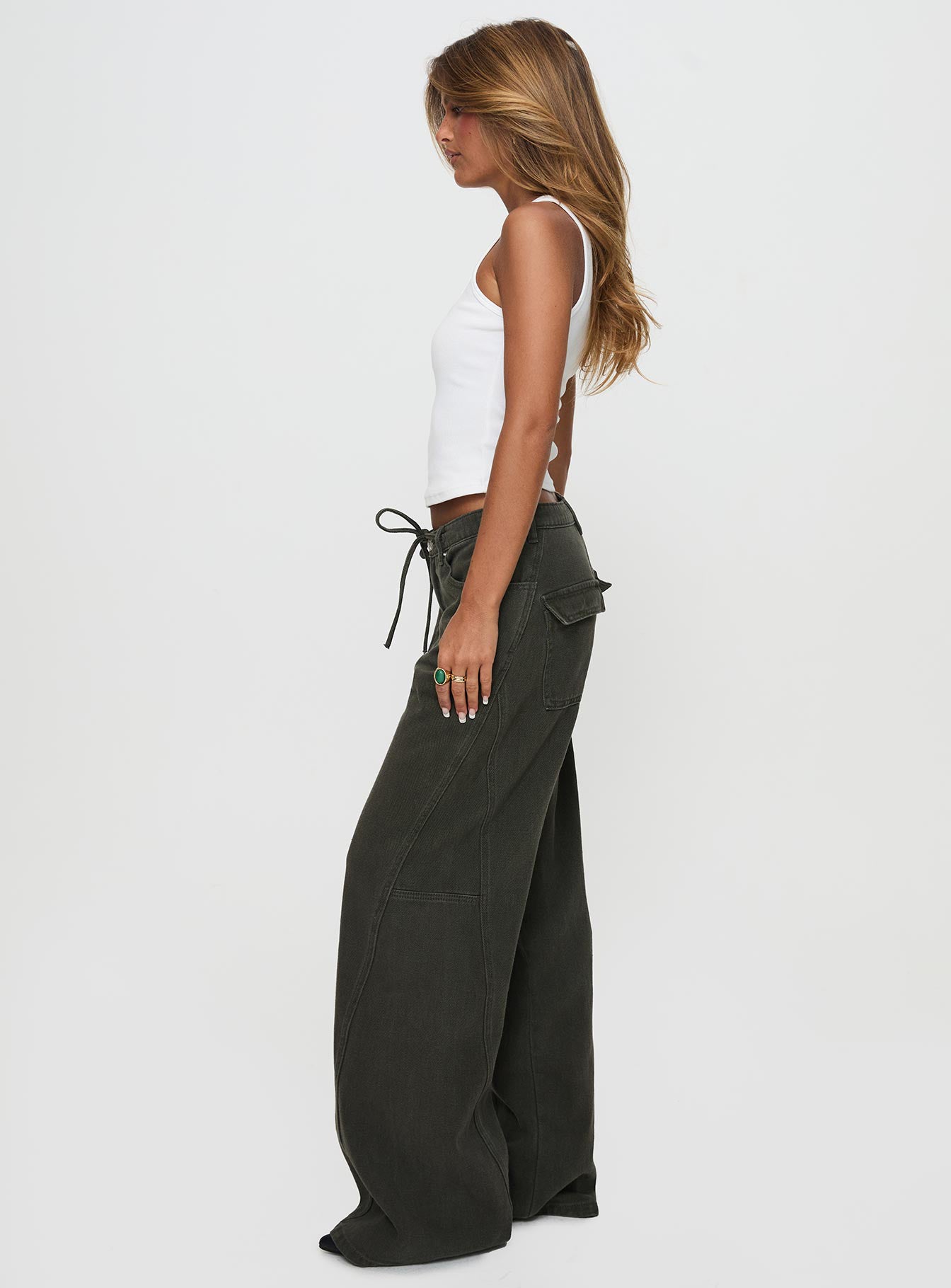 side view of model wearing Princess Polly Bruiser Tie Waist Mid Rise Wide Leg Jeans Green Petite High Rise Jeans 