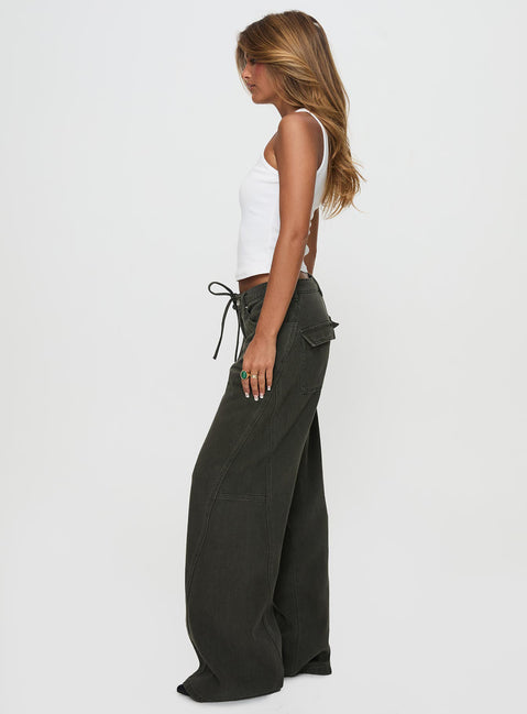 side view of model wearing Princess Polly Bruiser Tie Waist Mid Rise Wide Leg Jeans Green High Rise Jeans 