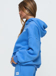 side view of model wearing Princess Polly Princess Polly Hooded Sweatshirt Bubble Text Blue / White Long 