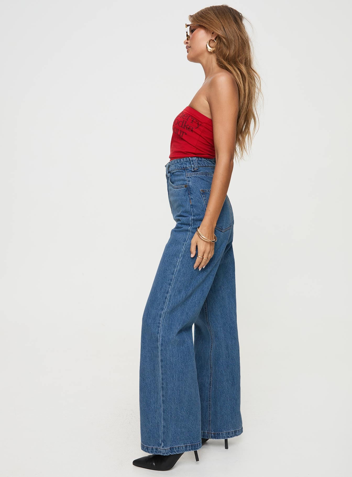 side view of model wearing Princess Polly Zephee Wide Leg Jeans Light Wash Petite High Waisted 