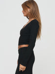 side view of model wearing Princess Polly Memi Long Sleeve Top Black Full Sleeves V-Neck 