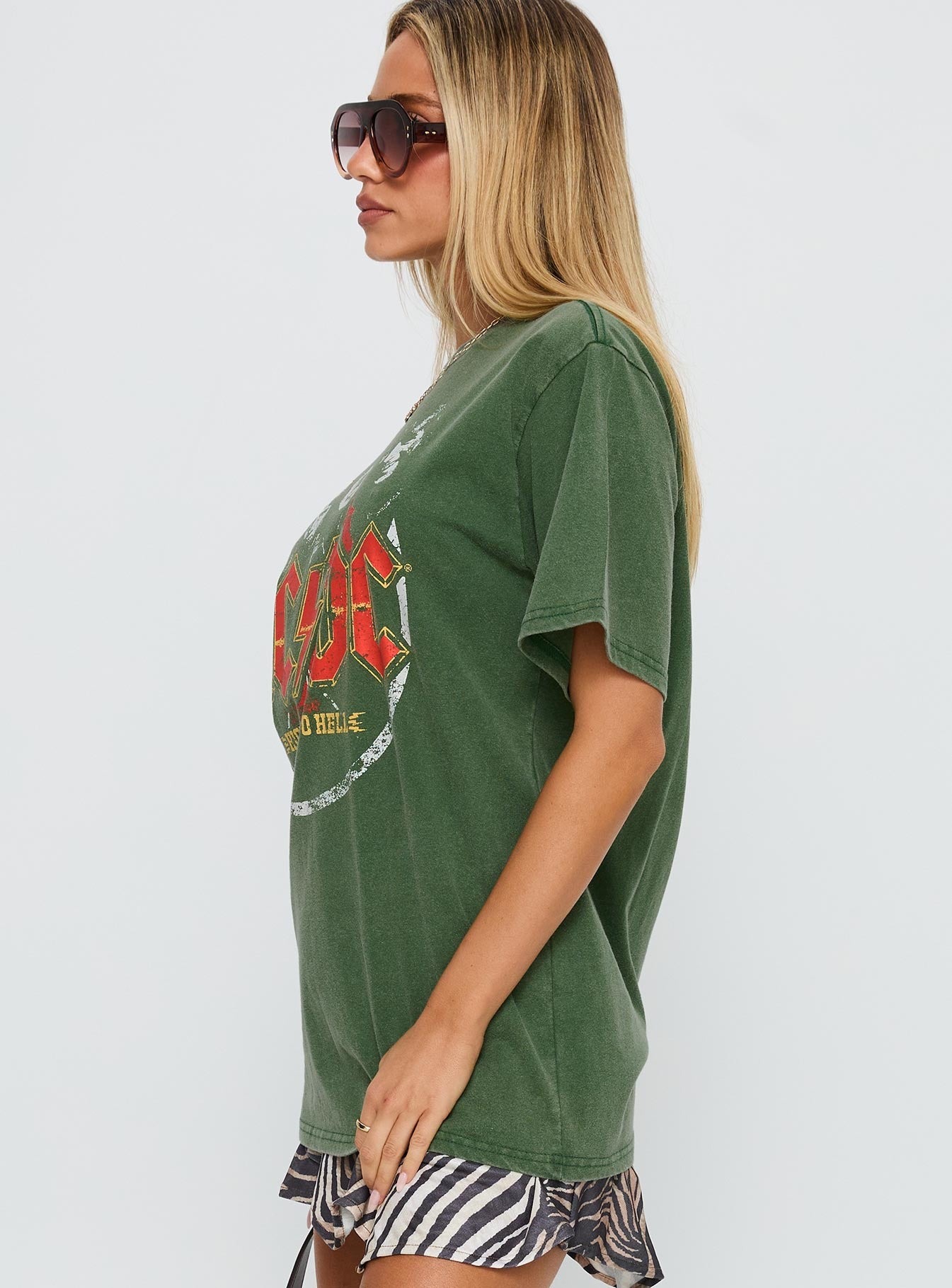 side view of model wearing Princess Polly Acdc Vintage Oversized Graphic Top Green Half Sleeves Crew Neck 