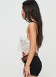 side view of model wearing Princess Polly Macchiato Halter Top Cream Sleeveless Plunger 