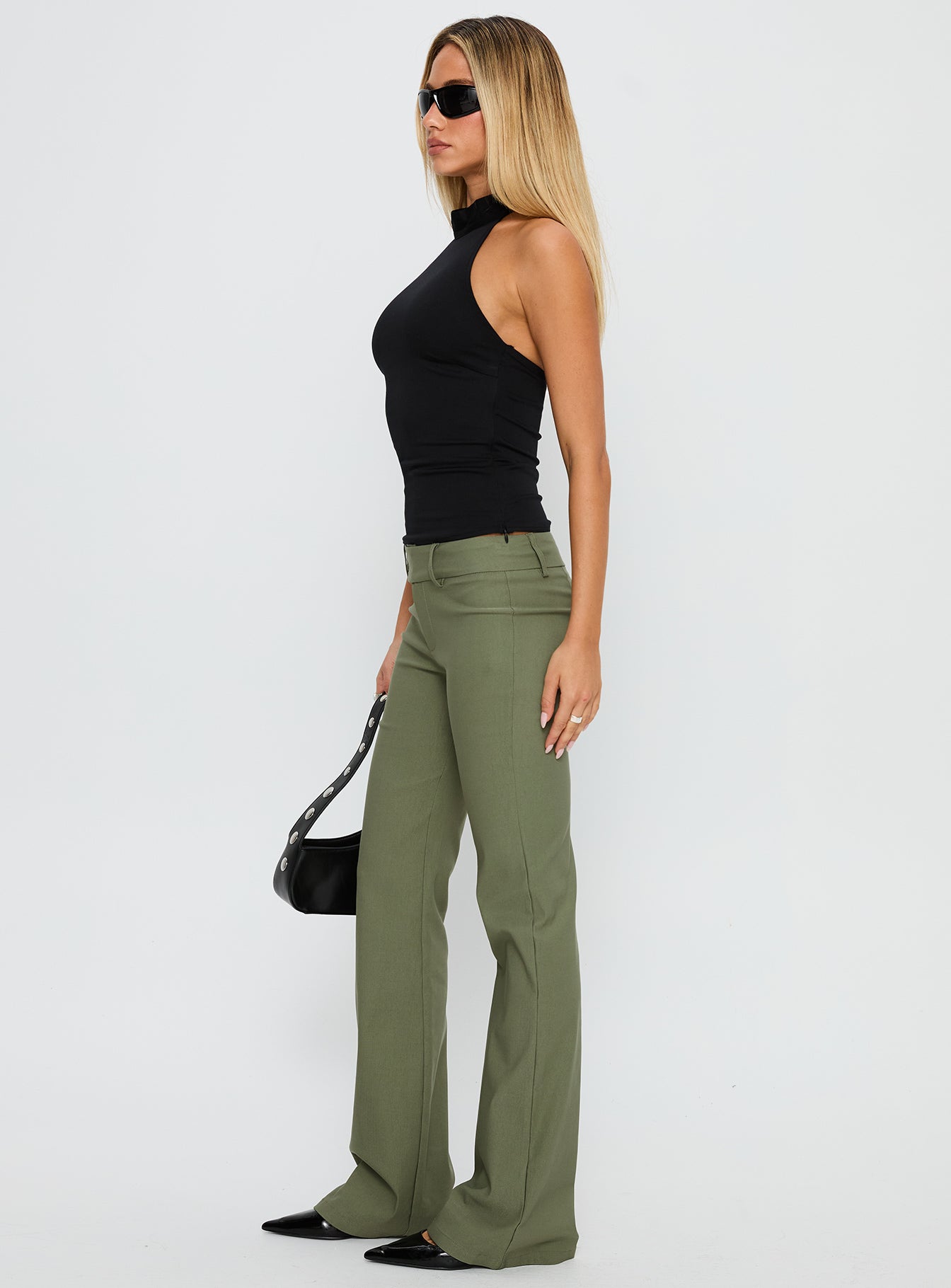 side view of model wearing Princess Polly Kinkirk Flared Pants Olive Green Low Rise Pants 