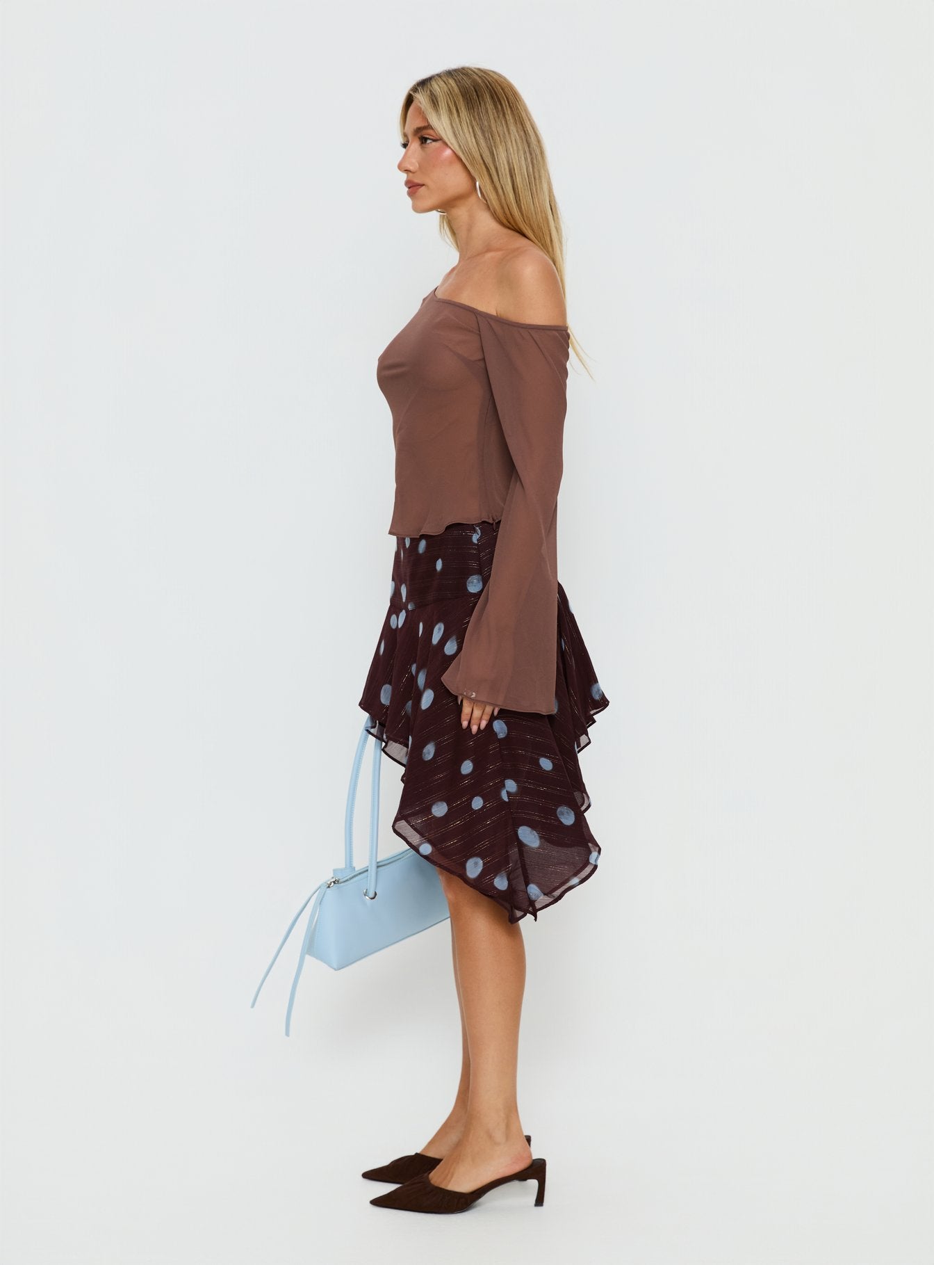   side view of model wearing Princess Polly Hevenna Asymmetrical Chiffon Mini Skirt Brown / Blue Polka 
