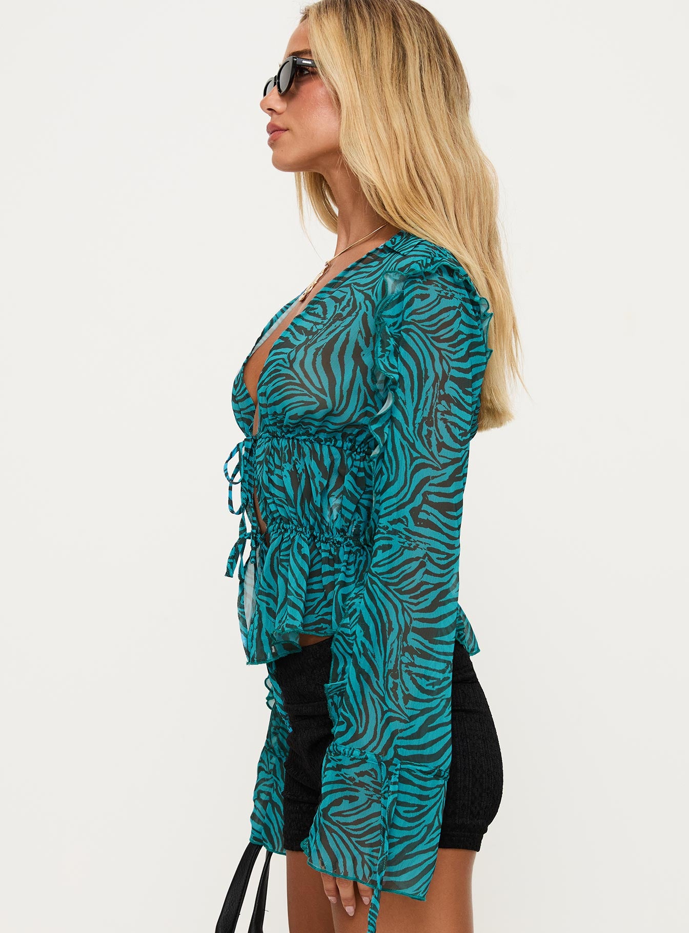 side view of model wearing Princess Polly Holidaze Long Sleeve Top Zebra Full Sleeves Plunger 