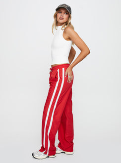 side view of model wearing Princess Polly Keli Track Pants Red / White High Waisted Pants 