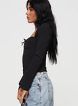 side view of model wearing Princess Polly Linsley Long Sleeve Top Black Full Sleeves Square Neck 