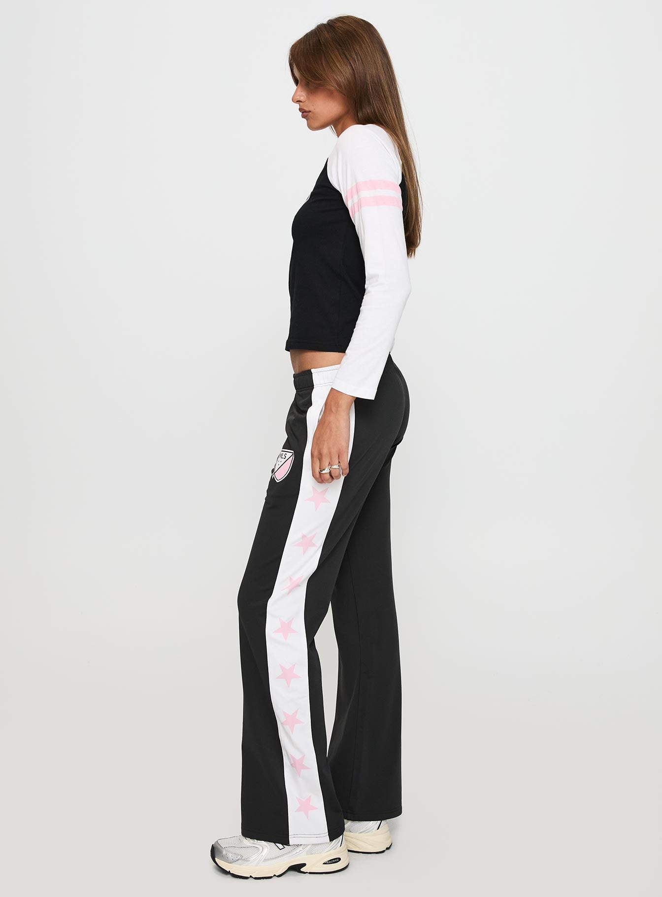 side view of model wearing Princess Polly Track Star Pants Black Low Rise Pants 