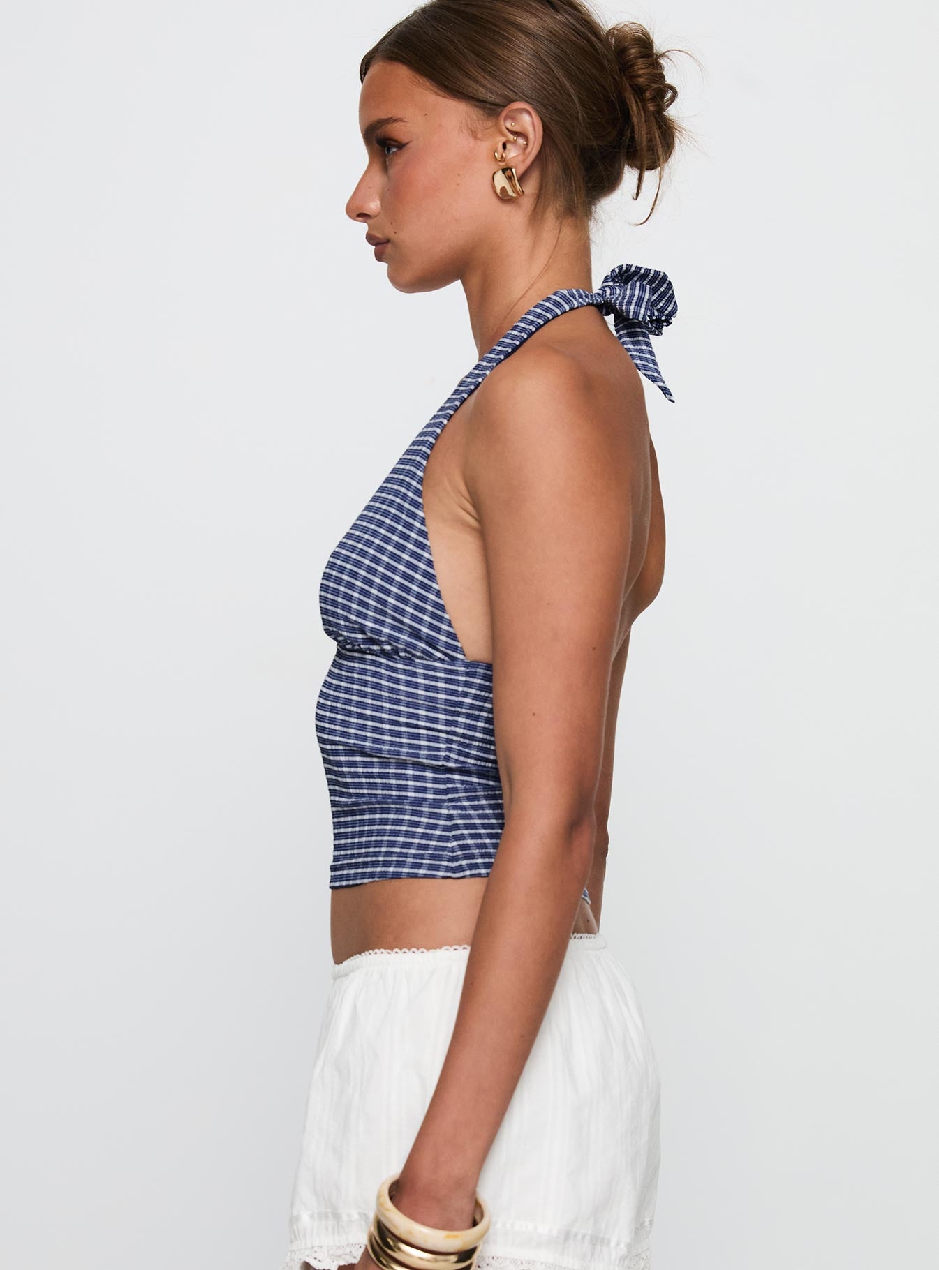 side view of model wearing Princess Polly Whimsy Halter Top Navy Gingham Sleeveless Sleeveless Plunger Plunger 