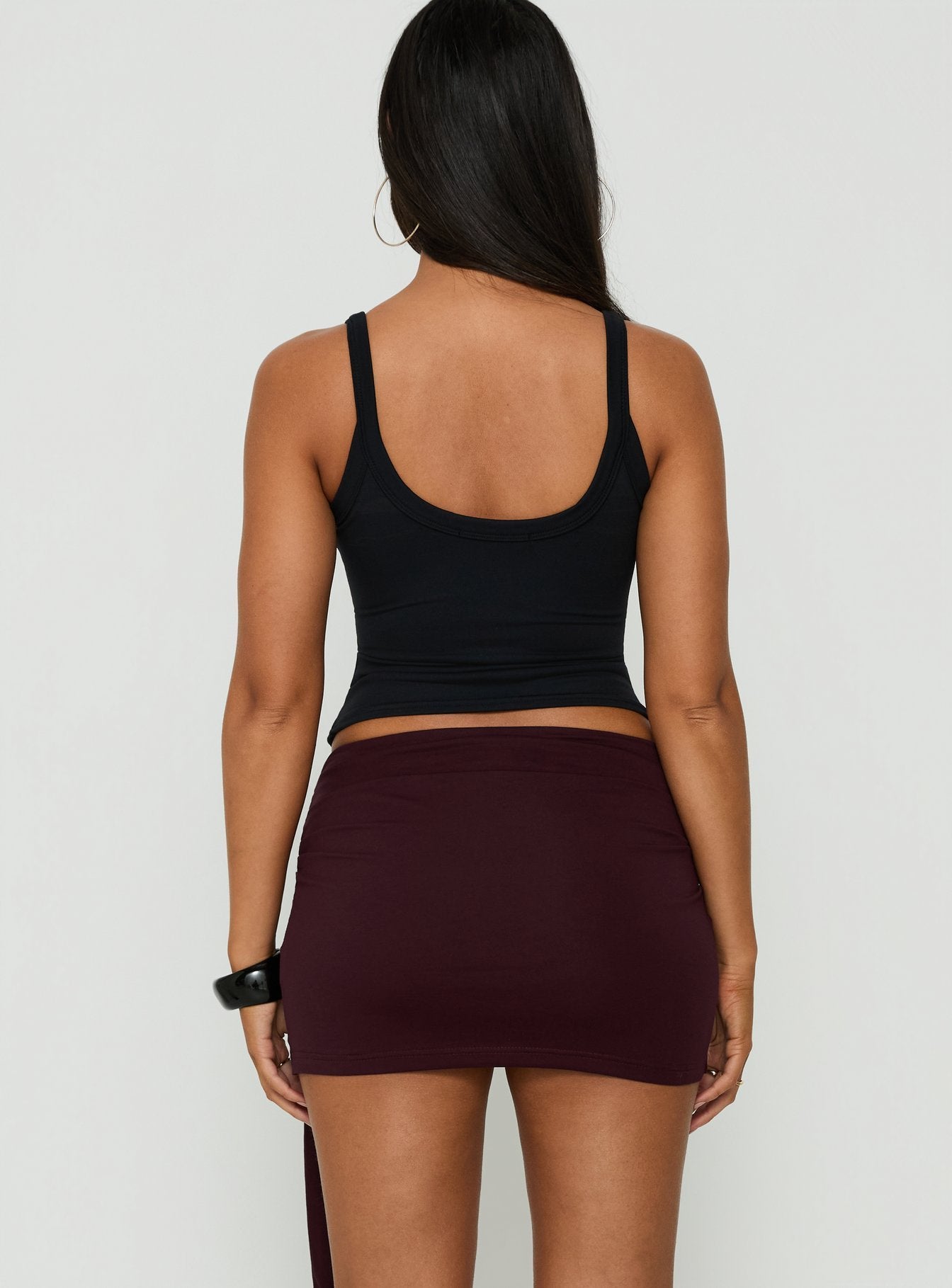 Featuring the Eldric Tie Waist Micro Skirt Aubergine womens-skirts in mini length back view of model wearing
