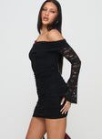 side view of model wearing Princess Polly Fable Off The Shoulder Mini Dress Black Straight Neck 